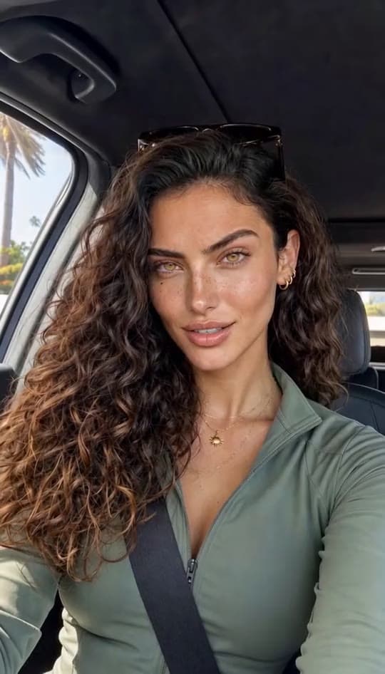 A woman rants to her phone camera from the driver's seat